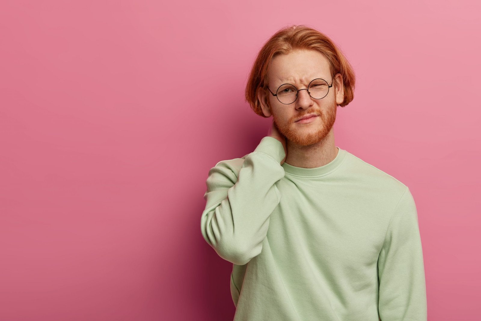 tired male student touches neck feels pains after working long with computer scaled