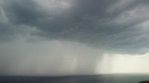 aerial view footage of rain clouds over sea ocean black clouds in bad weather day over sea surface